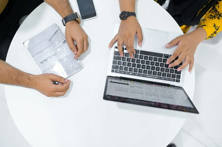 Nucleus consultants reviewing a client portfolio on a laptop